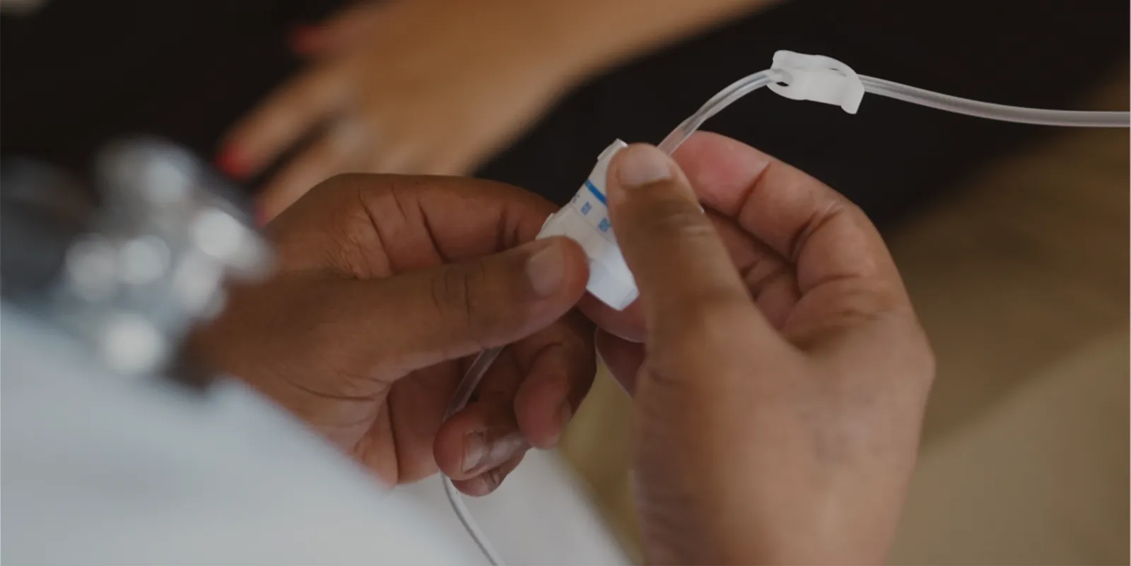 Nurse adjusting IV medication for a patient.